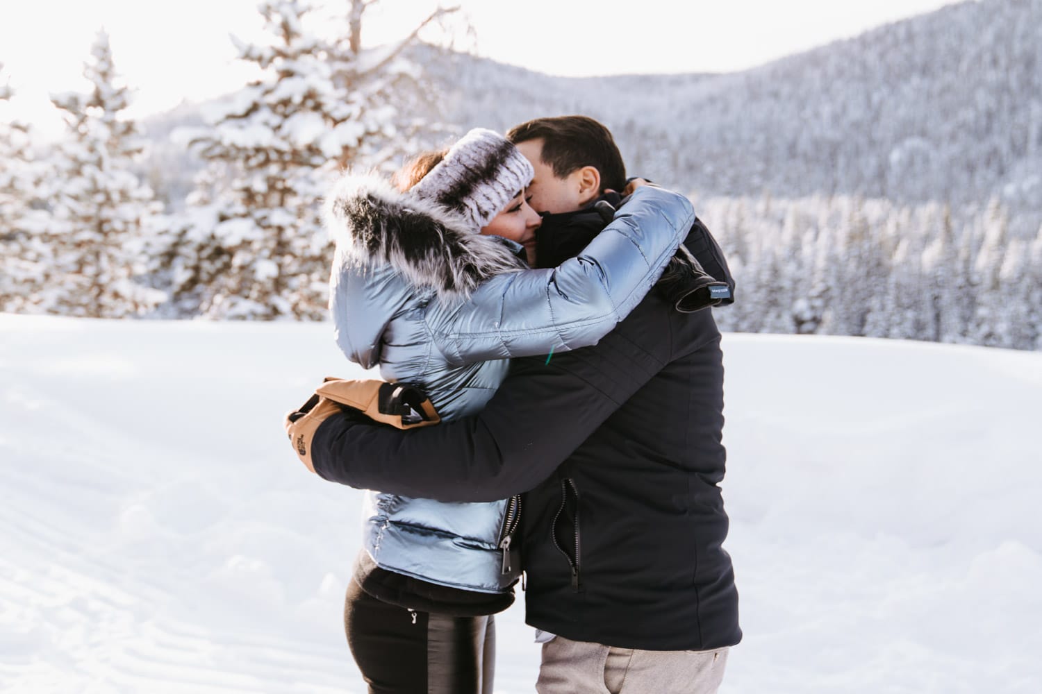 Emotional moment where Julio and Fernanda hug each other after just becoming engaged for this sleigh ride proposal in Breckenridge