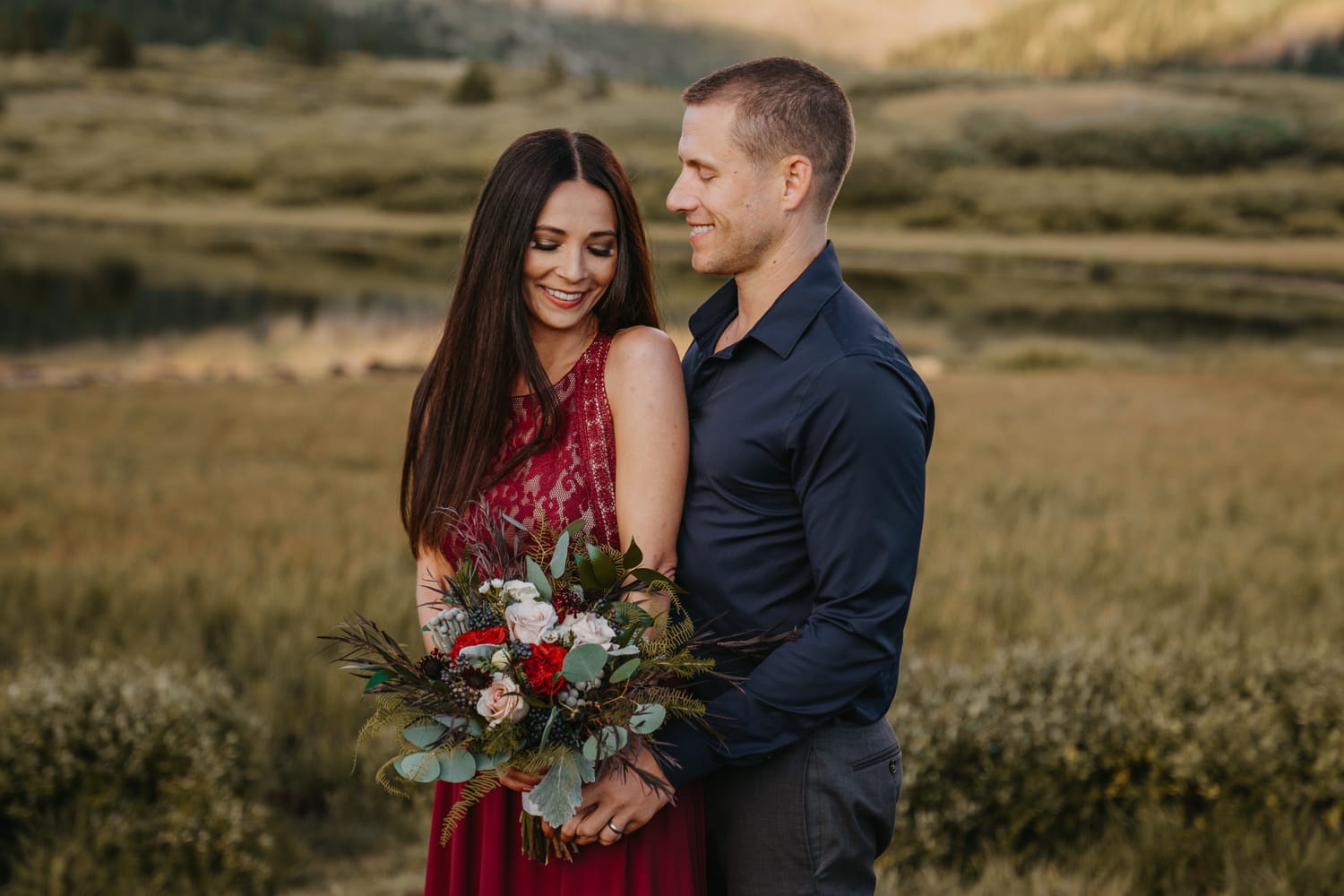 Newlywed couple poses together in front of Mt. Bierstadt on this calm summer night at the top of Guanella Pass. It was their first option when they were choosing a place to elope with their dog.