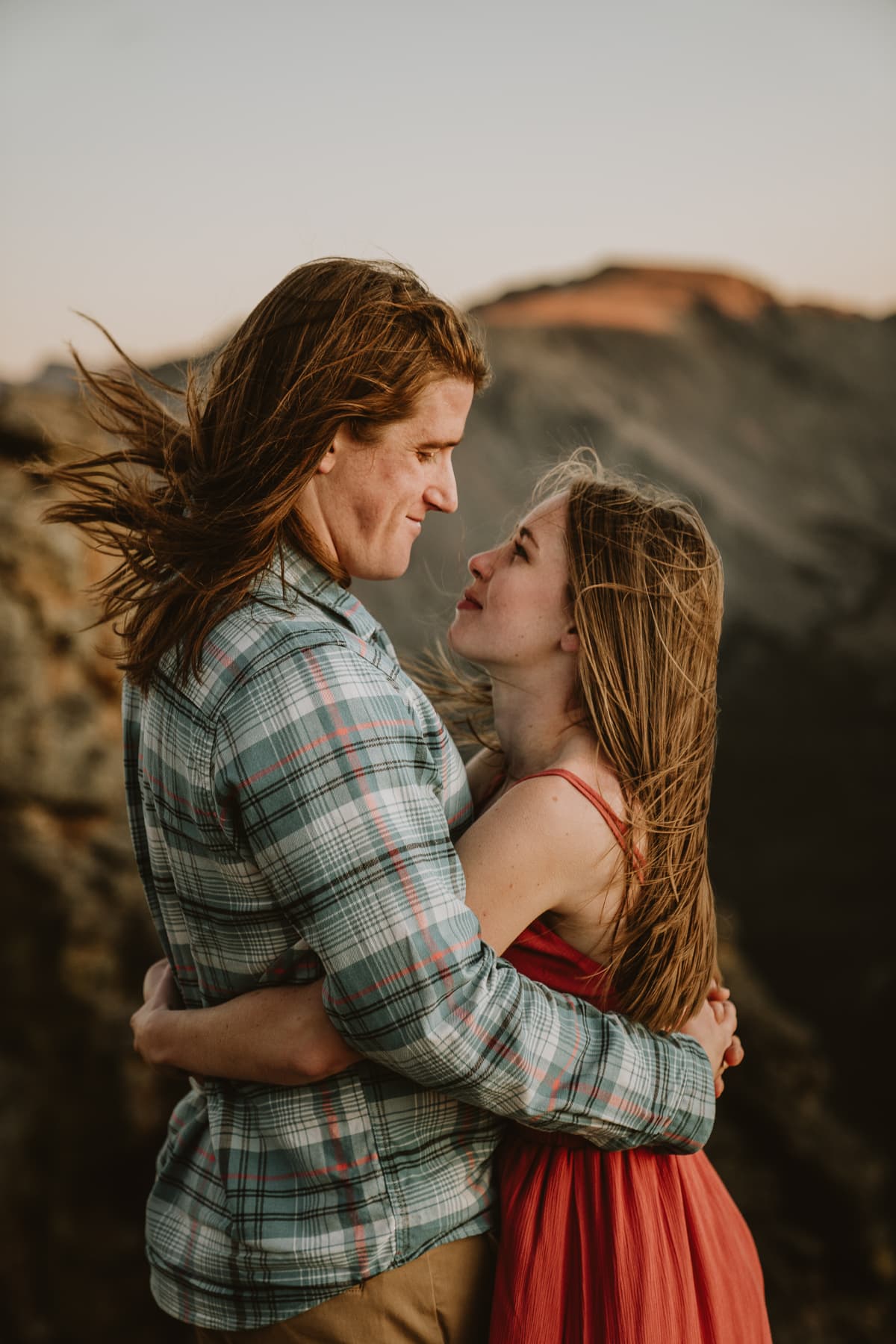 Couple stares into each others eyes during their engagement session on top of Trail Ridge Rd in Rocky Mountain National Park
