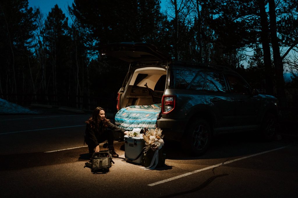 Self portrait of Paige Weber Photography loading up SUV in the dark