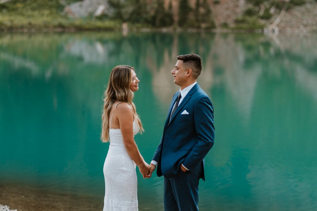 Couple who planned their summer hiking elopement next to a blue lake in Colorado.