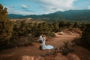 Newly married wedding couple stops on the dirt path during their sunset wedding at High Point Overlook in Garden of the Gods.