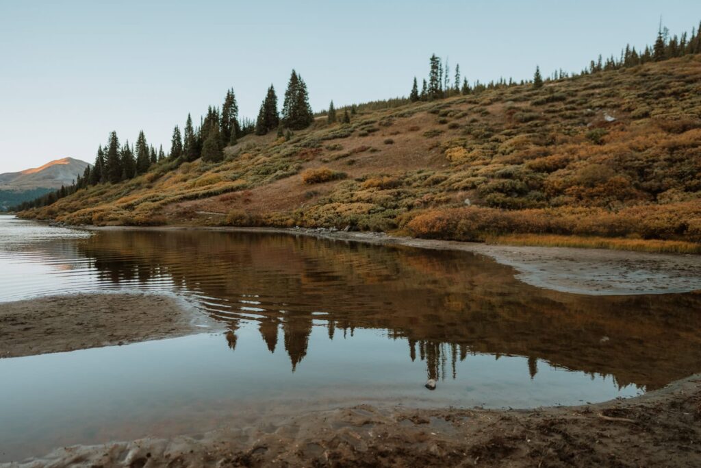 Landscape photo that shows how reflective the lake was and the fall foliage reflecting back in the lake.