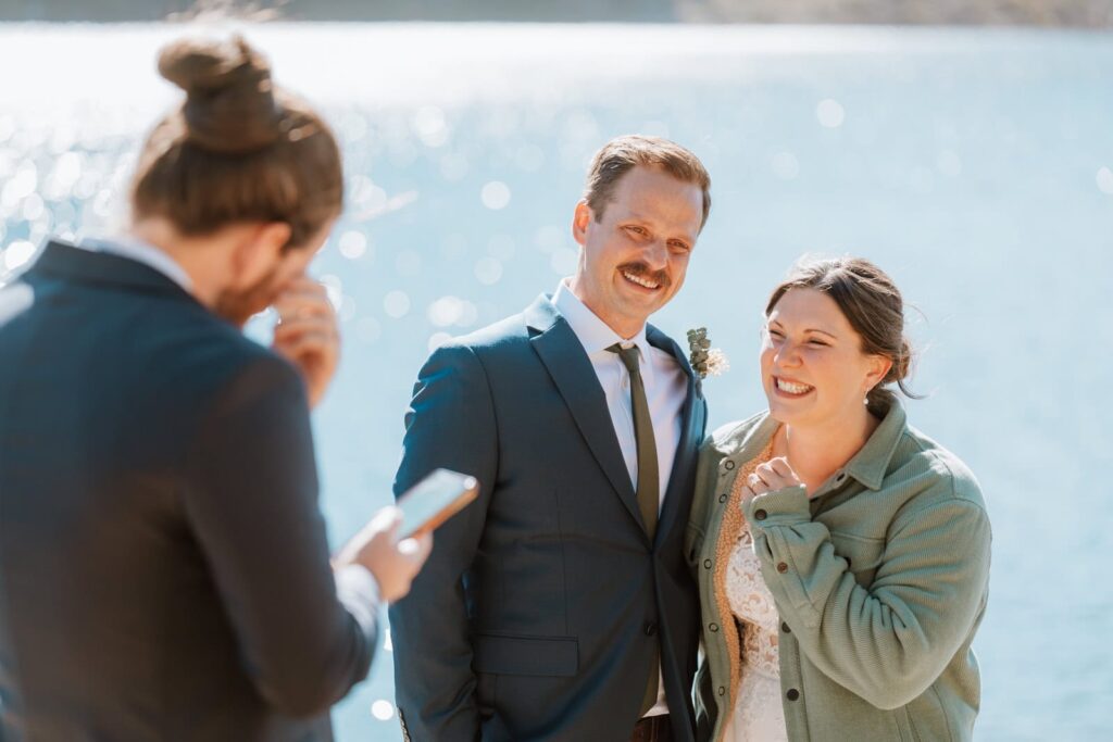 Both the bride and groom are laughing at the best man's speech.
