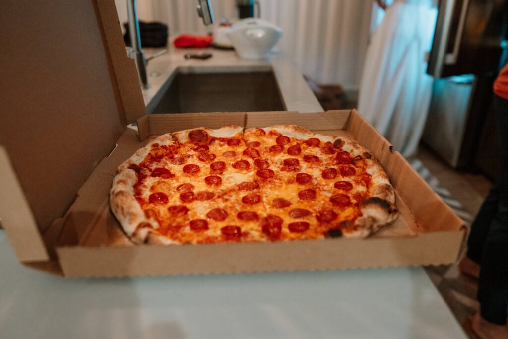Shown is a giant pepperoni pizza, the perfect celebration for a small mountain wedding in Colorado.