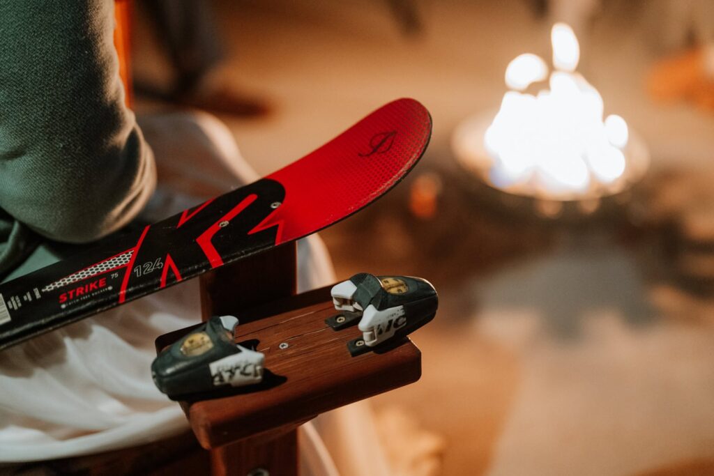 Closeup phot of the chair the bride is sitting in that's made out of skis and ski mounts.