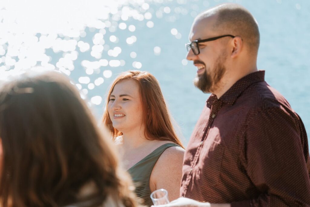 Closeup photo showing the smiling faces of two guests at the wedding.