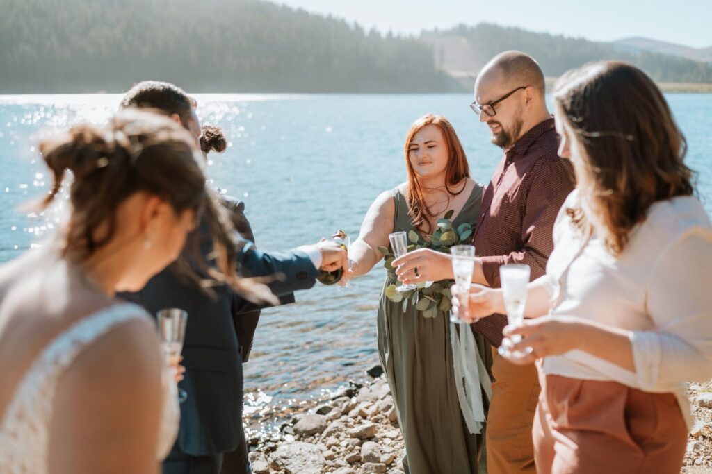 Bride and groom toast to their guests with champagne.