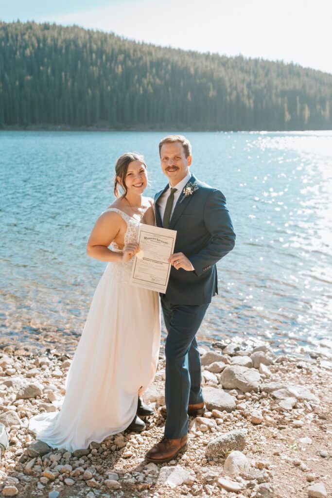 Bride and groom shown posing for a photo at Clinton Gulch in Breckenridge for their Colorado elopement.