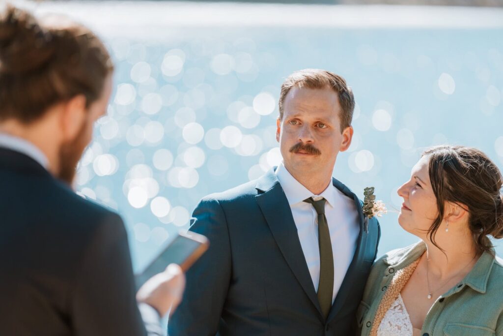 Close up photo to show the grooms reaction during his best man's speech during their small mountain wedding in Breckenridge, Colorado.