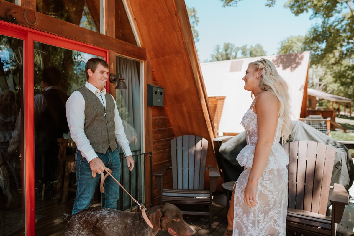 Bride and groom has a first look at their A frame AirBNB in Colorado before their elopement. The groom has a big smile on his face as he sees his bride for the first time.