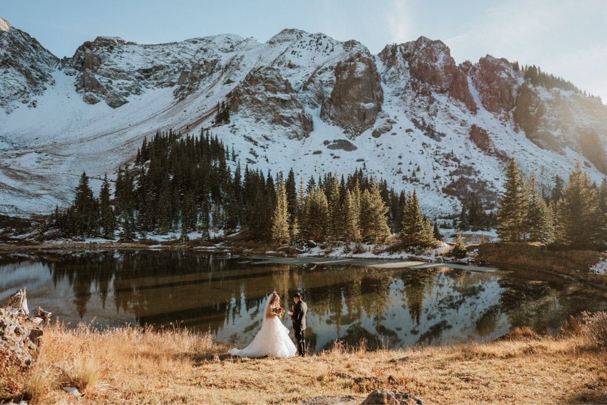 San Juan elopement ceremony by a reflective alpine lake after a 4x4 mountain drive