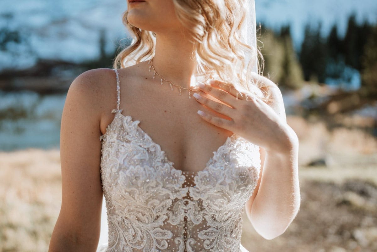 Close-up of bridal lace and necklace during an off-road elopement near Telluride