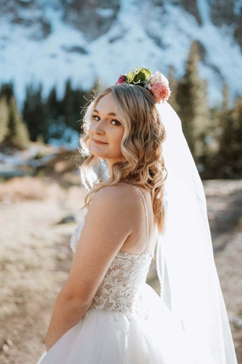 Bride wearing flower crown and veil before her Telluride mountain elopement