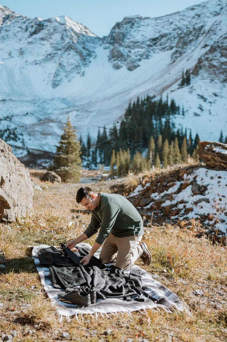 Groom organizing elopement gear before his 4x4 elopement in the Colorado mountains.