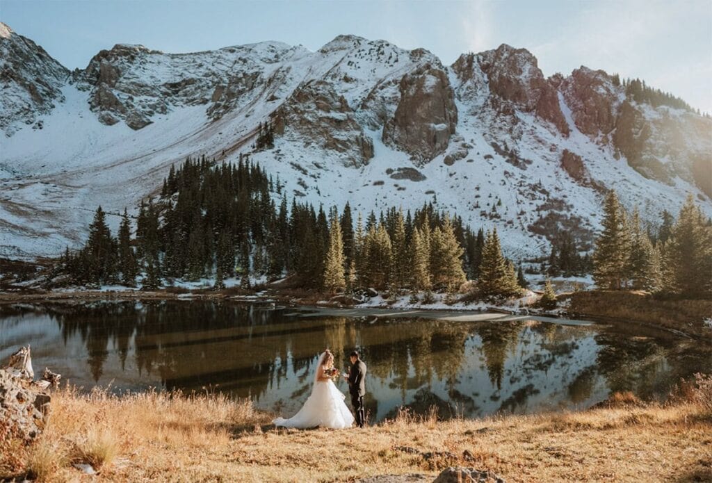 Couple exchanging vows by an alpine lake during their Telluride elopement in the San Juan Mountains.