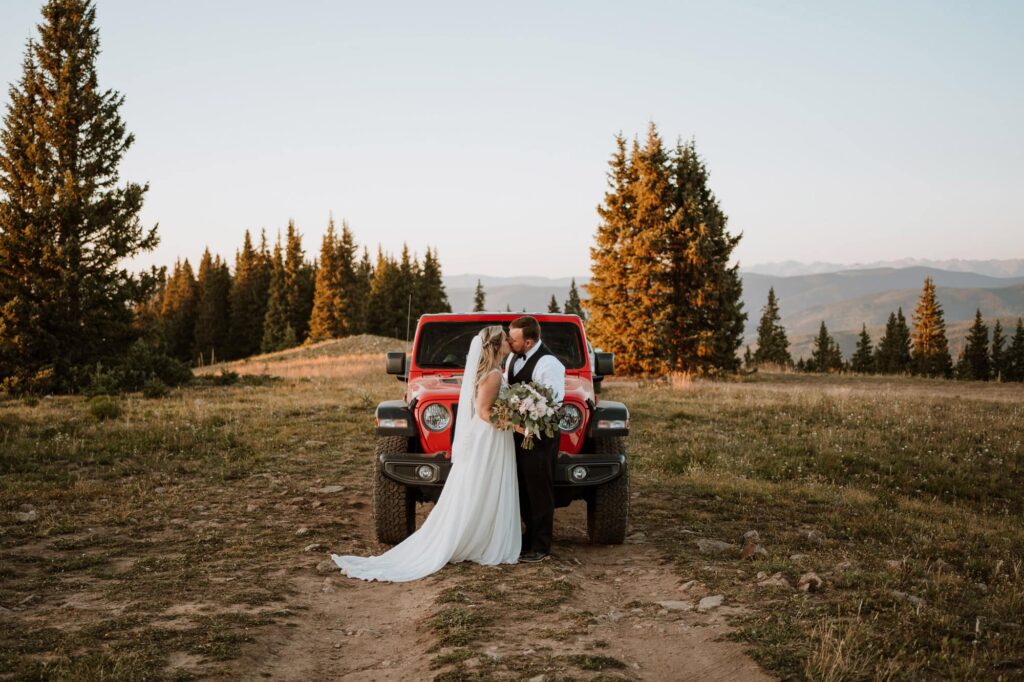 Bride and groom sharing a quiet moment in front of a jeep during a wedding at sunset in Aspen, Colorado.