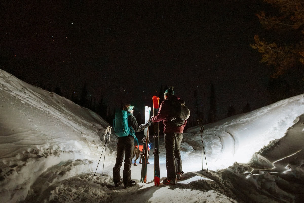 Couple ski touring at night during a winter elopement near Salida, Colorado